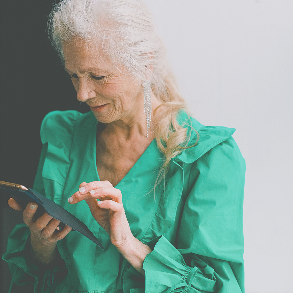 A woman using her mobile device, guiding the viewer onto the contact page where they can book home care visits.